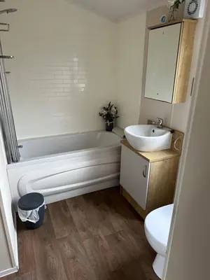 a bathroom with a tub and a sink and a toilet at 13 Chorley close in Walton-on-the-Naze