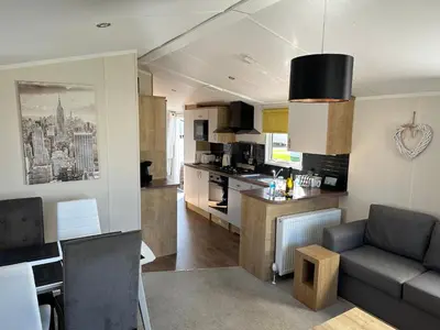 a kitchen and living room with a couch and a table at 13 Chorley close in Walton-on-the-Naze