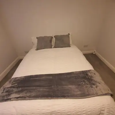 a large bed with two pillows on top of it at Beautiful and Cozy 2 Bedroom Apartment Billericay in Billericay