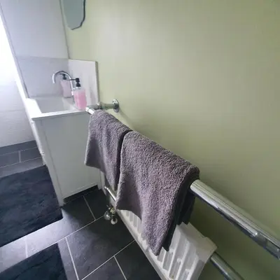 a bathroom with two towels and a sink at Beautiful and Cozy 2 Bedroom Apartment Billericay in Billericay
