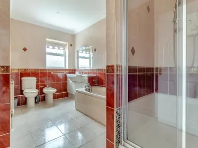 a bathroom with a tub and a toilet and a shower at The Great Escape in Ipswich