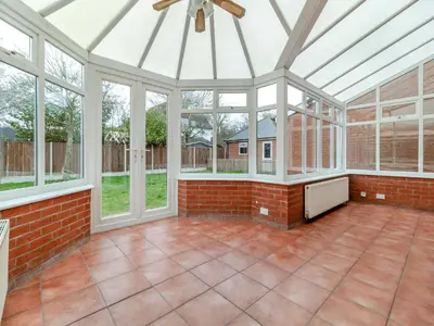 an empty conservatory with a glass ceiling and windows at The Great Escape in Ipswich