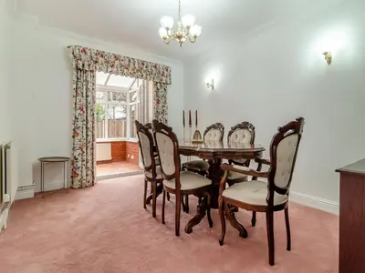 a dining room with a table and chairs at The Great Escape in Ipswich