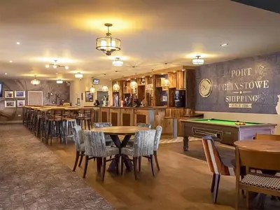 a restaurant with tables and chairs and a pool table at Forest Retreat in Saxmundham