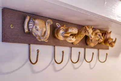 a shelf with a bunch of animal heads on it at Stylish Victorian house, close to City Centre in Colchester