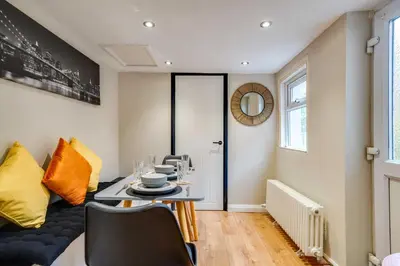 a dining room with a table and chairs at Stylish Victorian house, close to City Centre in Colchester