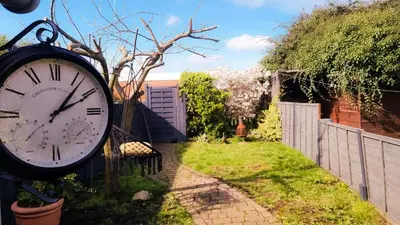 a clock in the yard of a house at Stylish Victorian house, close to City Centre in Colchester