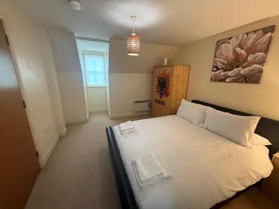 a bedroom with a large white bed in a room at Comfort Arena in Colchester