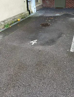 an empty parking lot with a white arrow on the street at Comfort Arena in Colchester