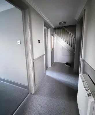 an empty hallway with a door and a staircase at Urban Oasis in Billericay