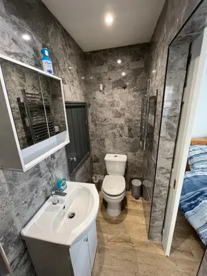 a bathroom with a white sink and a toilet at Seagull studio in Felixstowe