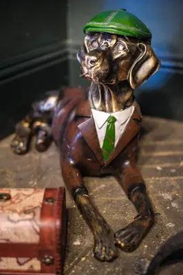 a statue of a dog wearing a green hat and tie at Luxury 3 Bed Manor House Hot Tub Cinema Room SkyTV in Saffron Walden