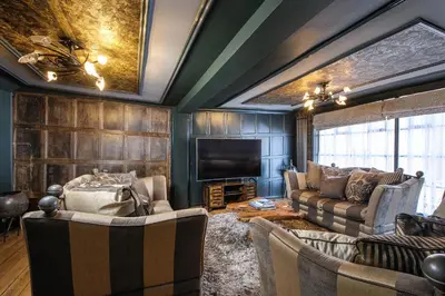 a living room with couches and a flat screen tv at Luxury 8 Bed Manor House Hot Tub Cinema Room SkyTV in Saffron Walden