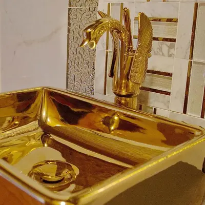 a gold sink with a faucet in a bathroom at Luxury 8 Bed Manor House Hot Tub Cinema Room SkyTV in Saffron Walden