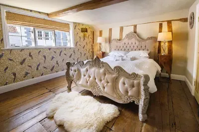 a bedroom with a large white bed and a window at Luxury 8 Bed Manor House Hot Tub Cinema Room SkyTV in Saffron Walden