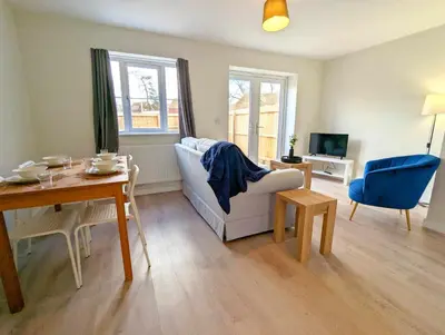 a living room with a couch and a table at 3-Bed, Sleeps 5, 3 Bath, Parking, WiFi in Watton