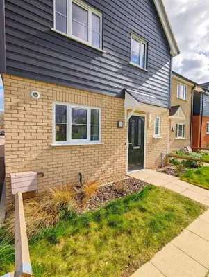 a brick house with a blue roof and a door at 3-Bed, Sleeps 5, 3 Bath, Parking, WiFi in Watton