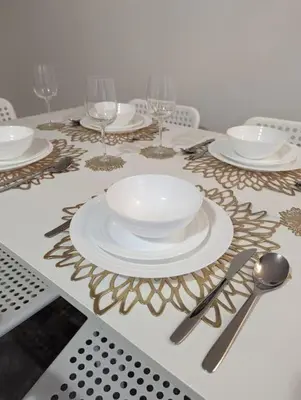 a table with plates and silverware on a table at 2-Bed, Sleeps 5, 2 Bath, Parking, WiFi in Colchester