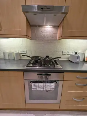 a kitchen with a stove with pots and pans on it at 2-Bed, Sleeps 5, 2 Bath, Parking, WiFi in Colchester