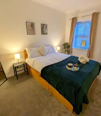 a bedroom with a bed with a tray of food on it at 2-Bed, Sleeps 5, 2 Bath, Parking, WiFi in Colchester