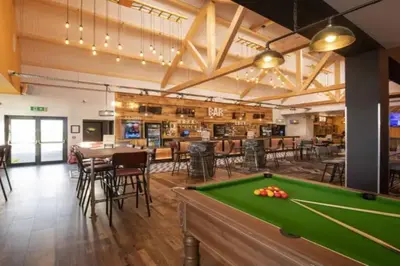 a pool table in a room with a bar at VerbZen Holiday Caravan at St Osyth Beach, Clacton-on-Sea by Verb Holidays in Saint Osyth