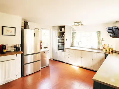 a kitchen with wooden floors and stainless steel appliances at Prospect Place by The Suffolk Cottage Collection in Westleton