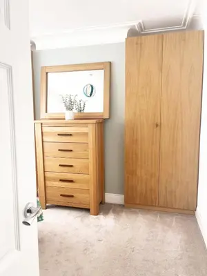 a bedroom with a wooden dresser and a mirror at Spacious 3 Bedroom Home, Sleeps 7, Long-Stay & Contractor Friendly, Family & Professional Ready, Clark Property Estates in Southend-on-Sea