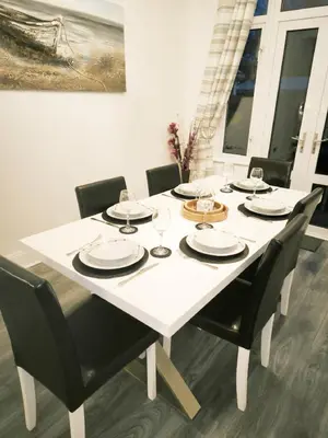 a white table with black chairs and a white dining room at Spacious 3 Bedroom Home, Sleeps 7, Long-Stay & Contractor Friendly, Family & Professional Ready, Clark Property Estates in Southend-on-Sea