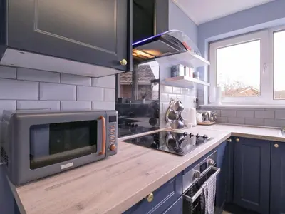 a kitchen with a microwave and a stove top oven at The Upper Circle in Clacton-on-Sea