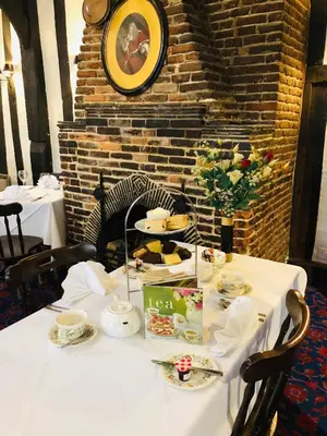a white table with plates of food on it at Brook Red Lion Hotel in Colchester