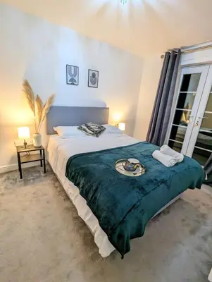 a bedroom with a large bed with a plate on it at 2-Bed, Sleeps 5, 2 Bath, Parking, WiFi in Colchester