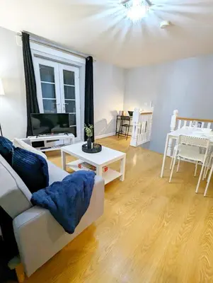 a living room with a white couch and a tv at 2-Bed, Sleeps 5, 2 Bath, Parking, WiFi in Colchester