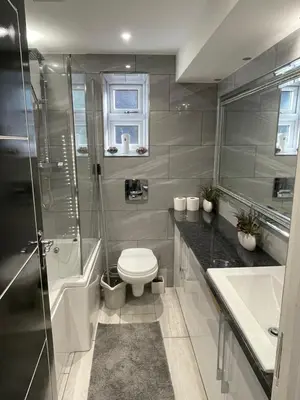 a bathroom with a toilet and a shower and a sink at Brook House Annex in Ipswich