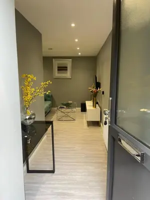 a hallway with a living room with a table at Brook House Annex in Ipswich