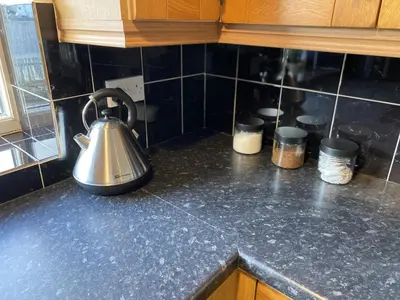 a tea kettle on a counter in a kitchen at Charming 3 bedroom flint cottage in Lakenheath