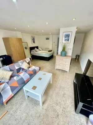 a living room with a couch and a table at Cambridge City Centre Studio, Sleeps 3 in Cambridge