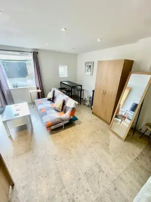 a living room with a couch and a table at Cambridge City Centre Studio, Sleeps 3 in Cambridge