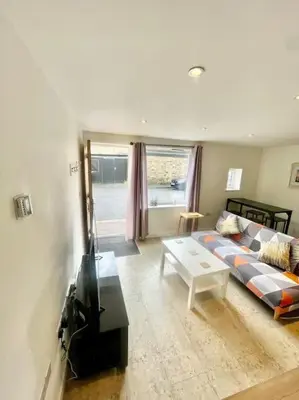 a living room with a couch and a table at Cambridge City Centre Studio, Sleeps 3 in Cambridge