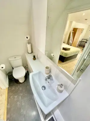 a bathroom with a sink and a toilet and a mirror at Cambridge City Centre Studio, Sleeps 3 in Cambridge