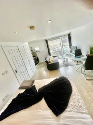 a bedroom with a bed with a bow tie on it at Cambridge City Centre Studio First Floor Sleeps 3 in Cambridge