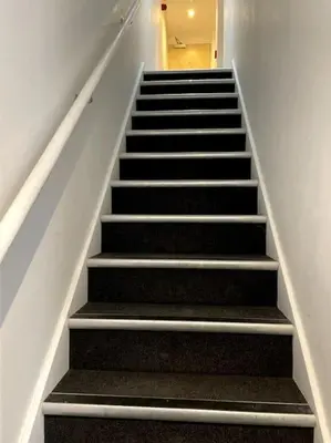 a staircase with black steps in a building at Cambridge City Centre Studio First Floor Sleeps 3 in Cambridge