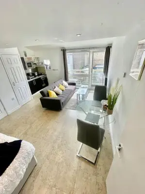 a living room with a couch and a glass table at Cambridge City Centre Studio First Floor Sleeps 3 in Cambridge