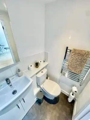 a white bathroom with a toilet and a sink at Cambridge City Centre Studio First Floor Sleeps 3 in Cambridge