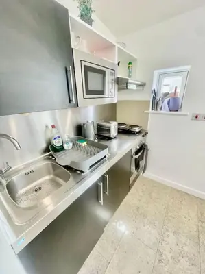 a kitchen with a sink and a microwave at Cambridge City Centre Studio First Floor Sleeps 3 in Cambridge