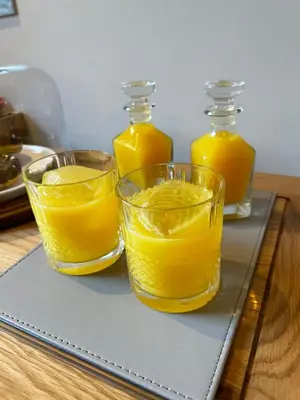 three glasses of orange juice on a cutting board at Stansted Airport Stay, Parking and Luxury Suite in Bishops Stortford