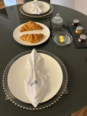 a table with plates of food on top of it at Stansted Airport Stay, Parking and Luxury Suite in Bishops Stortford