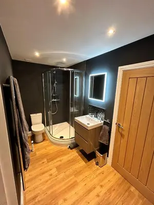 a bathroom with a shower and a toilet and a sink at Stansted Airport Stay, Parking and Luxury Suite in Bishops Stortford