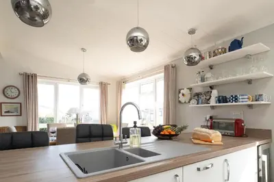 a kitchen with a sink and a counter at Pebbles - Church Farm - Aldeburgh Coastal Cottages in Aldeburgh