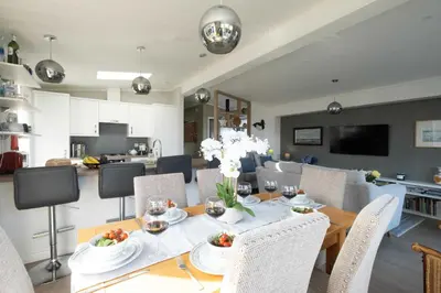 a dining room and kitchen with a table and chairs at Pebbles - Church Farm - Aldeburgh Coastal Cottages in Aldeburgh