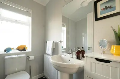 a bathroom with a white toilet and a sink at Pebbles - Church Farm - Aldeburgh Coastal Cottages in Aldeburgh